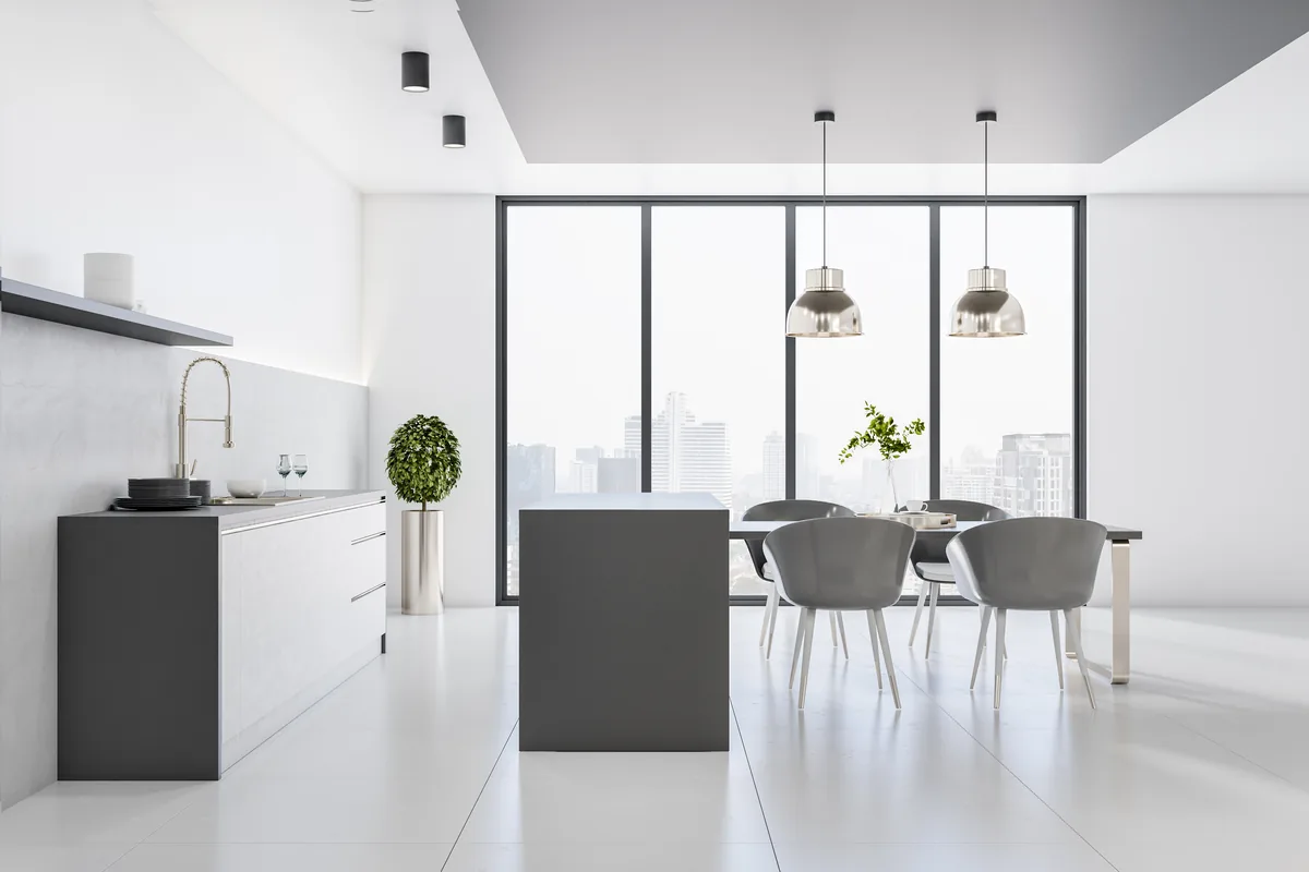 Pavimenti per cucina in gres di grande formato effetto cemento bianco in una cucina luminosa e minimale